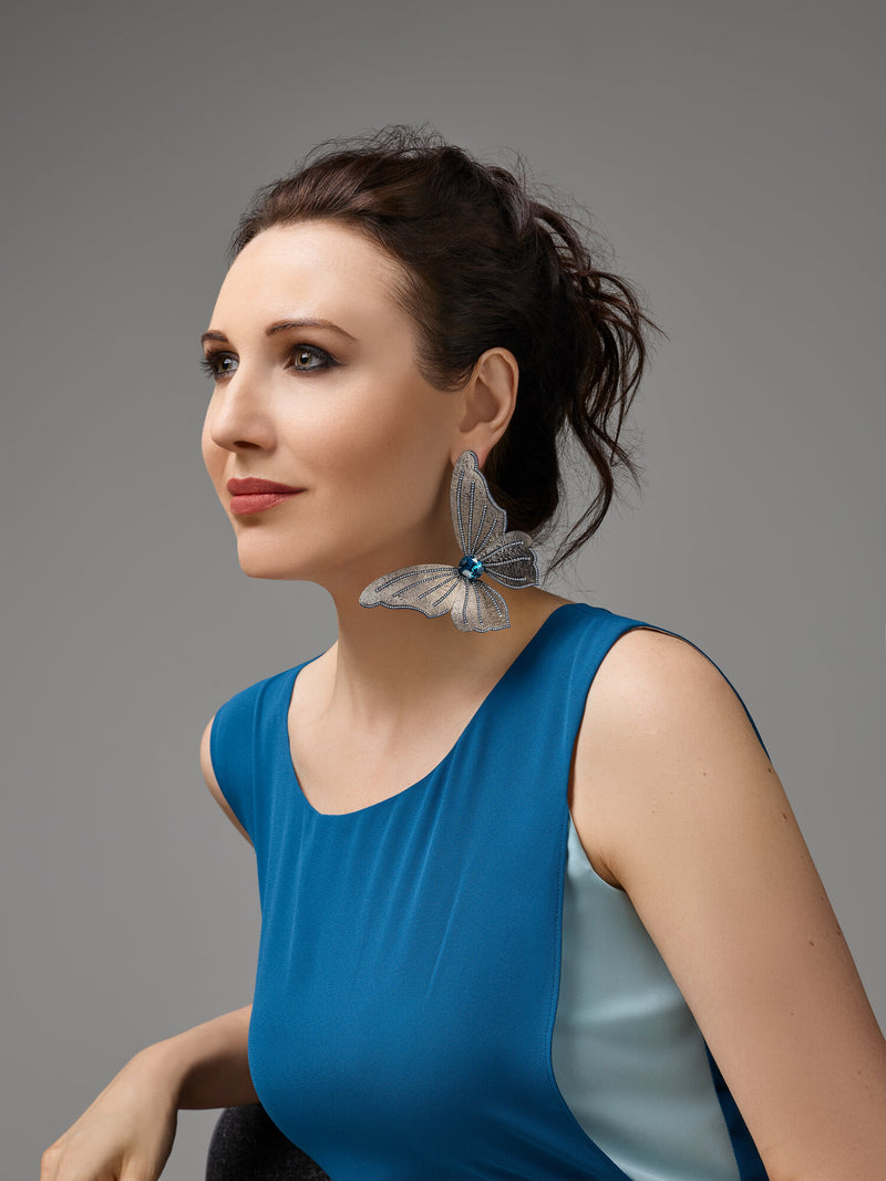 Image of Katerina Perez wearing blue butterfly earring