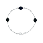 A flat-lay image of Juraster’s Sterling Silver Black Onyx Adjustable Bracelet, Three Wishes, crafted from Fairmined sterling silver and hand-cut black onyx.