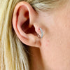 A model wearing Juraster’s 9ct White Gold Diamond Hoop Earring, Anchor, crafted from Fairmined white gold and conflict-free diamonds, in her tragus.