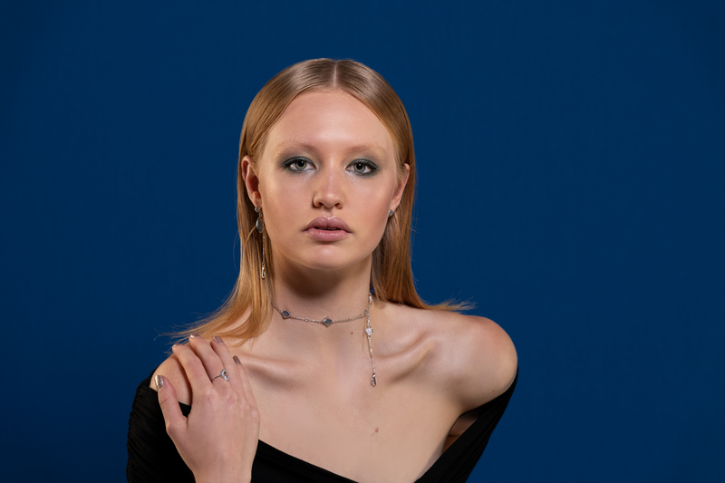 A woman wearing a necklace and a ring