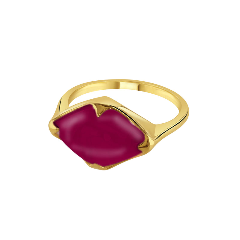Gold ring with a red gemstone on a white background