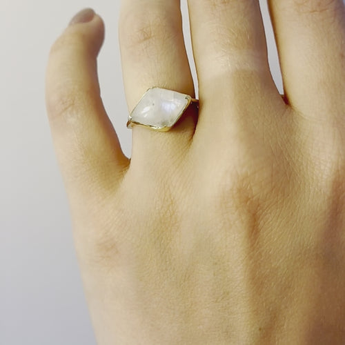 A video of a model wearing Juraster’s 9ct Gold Rainbow Moonstone Statement Ring, Talisman, crafted from Fairmined 9ct yellow gold and a hand-cut moonstone.