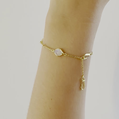 A video of a model wearing Juraster’s 9ct Gold Rainbow Moonstone Adjustable Bracelet, Three Wishes, crafted from Fairmined 9ct yellow gold and hand-cut rainbow moonstones.